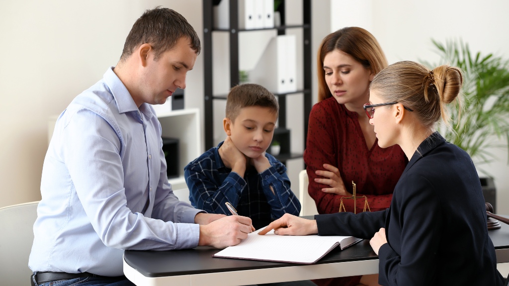 Divorced parents with their son visiting lawyer