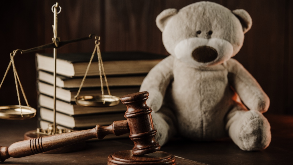 Wooden gavel and teddy bear